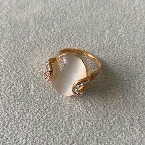 Ring with selenite cabochon set in rose gold tone with white stones